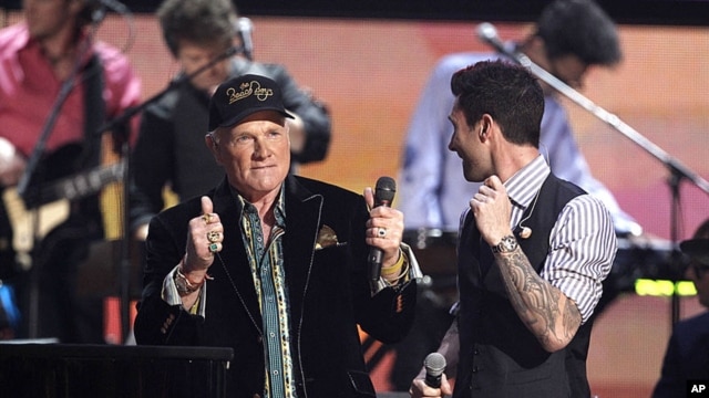 Mike Love of the band Beach Boys and Adam Levine, right, of the band Maroon 5 speak onstage after performing during the 54th annual Grammy Awards in Los Angeles, February 12, 2012. (AP Photo/Matt Sayles)