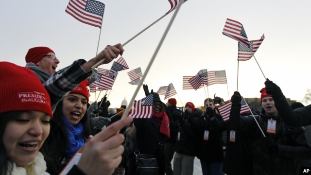 Spectators wave American flags on the National Mall in Washington, Jan. 21, 2013, before the start of President Barack Obama's ceremonial swearing-in ceremony during the 57th Presidential Inauguration.