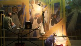 Conservators at work in July 2012 on the West Wall of The Meaning of Social Security