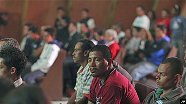Central American migrants attend a prayer service for missing and killed migrants - trying to cross Mexico to get to the US, who increasingly have become targets of gangs who kidnap them to obtain ransom money - at a migrant shelter in Lecheria, Mexico, J