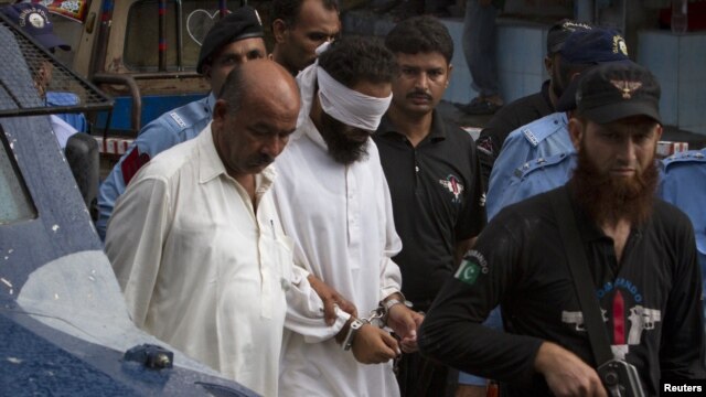 Police escort blindfolded Muslim cleric Khalid Jadoon on suspicion of framing Christian girl Rimsha Masih who was arrested under the country's controversial anti-blasphemy, September 2, 2012.