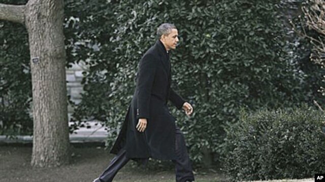 President Barack Obama walks back to the Oval Office of the White House in Washington, where he was scheduled to meet with members of his National Security team to discuss the events in Egypt, February 10, 2011