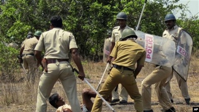 Indian police officers use batons on a villager opposing a government plan to build a nuclear power plant in Jaitapur, Maharashtra state, India, April 19, 2011