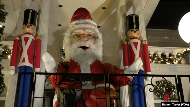 A 15-foot tall, 800-pound robotic Santa Claus, along with wooden toy soldiers, adorn the Polizzottos' home in Dyker Heights, New York.