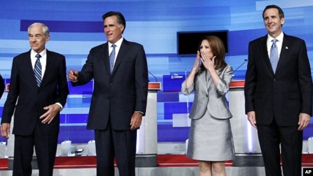 U.S. Republican presidential candidates Ron Paul (L), Mitt Romney (2nd L), Michele Bachmann and Tim Pawlenty (R) gather before the start of their debate in Ames, Iowa August 11, 2011