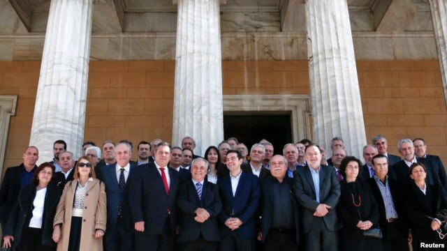 Greek Prime Minister Alexis Tsipras (front row C) and members of his government pose for a group picture after the first meeting of the new Cabinet in the parliament building in Athens, Jan. 28, 2015. 