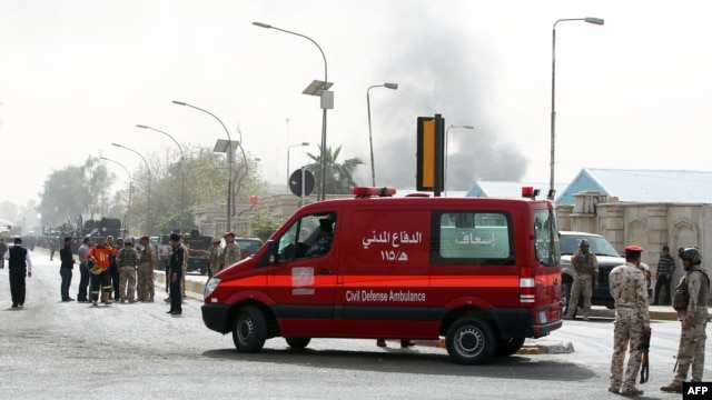 An ambulance arrives at the scene of a bomb attack in Baghdad, March 14, 2013.