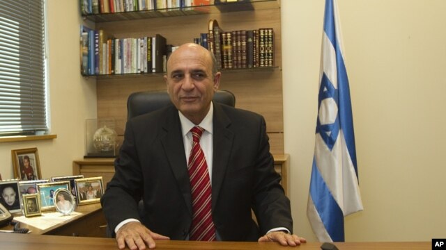 Shaul Mofaz, head of the centrist Kadima party, poses for a photo in his office at parliament in Jerusalem, before he was sworn in as a cabinet minister.