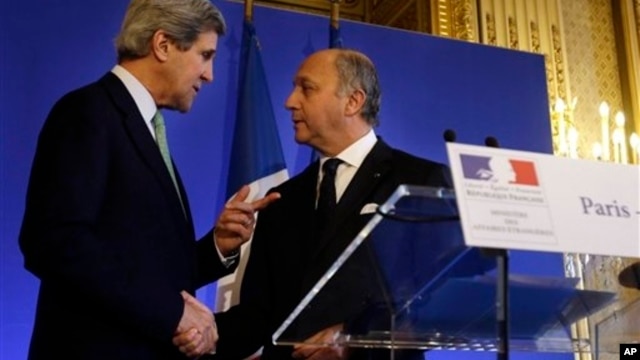U.S. Secretary of State John Kerry, left, shakes hands with French Minister of Foreign Affairs Laurent Fabius, Paris, Feb. 27, 2013.