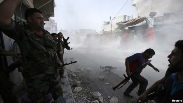 Free Syrian Army fighters run for cover after Syrian forces fired a mortar in the El Amreeyeh neighborhood of Syria's northwestern city of Aleppo August 30, 2012.