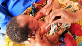 A health worker administers immunization to a displaced child at Nyakabande refugee transit camp in Kisoro town, 521 kilometers southwest of Uganda's capital Kampala, July 13, 2012.