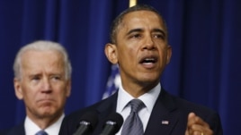 US President Barack Obama (R) unveils a series of proposals to counter gun violence as Vice President Joe Biden looks on during an event at the White House in Washington, January 16, 2013.