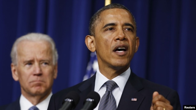 US President Barack Obama (R) unveils a series of proposals to counter gun violence as Vice President Joe Biden looks on during an event at the White House in Washington, January 16, 2013.