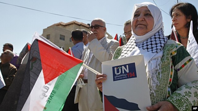 Palestinian activist Latifa Abu Hmeid holds a letter addressed to the UN Secretary-General Ban Ki-moon in front of the UN headquarters in the West Bank city of Ramallah, September 8, 2011.