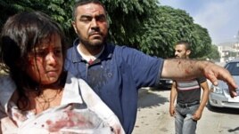 Injured Syrians arrive at a field hospital after an air strike hit their homes in the town of Azaz on the outskirts of Aleppo, Syria, Aug. 15, 2012.