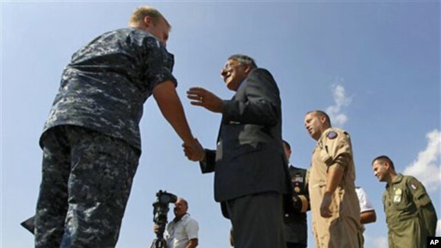 U.S. Defense Secretary Leon Panetta greets personnel while visiting the Sigonella Naval Air Station and NATO regional operations center, in Sigonella, Italy, October 7, 2011.