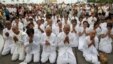 People wearing white pray as they mourn the late Cambodia