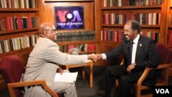 VOA’s Somali Chief Abdirahman Yabarow (left) greets President Hassan Sheikh Mohamud