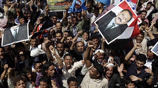 Supporters of Yemen's President Ali Abduallah Saleh hold portraits of the leader and chant slogans during a rally celebrating his return to Sana'a, Yemen, September 23, 2011.