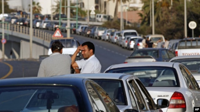 Drivers talk as they wait for fuel in a queue stretching for some hundreds of meters, in central Tripoli, Libya, (File)