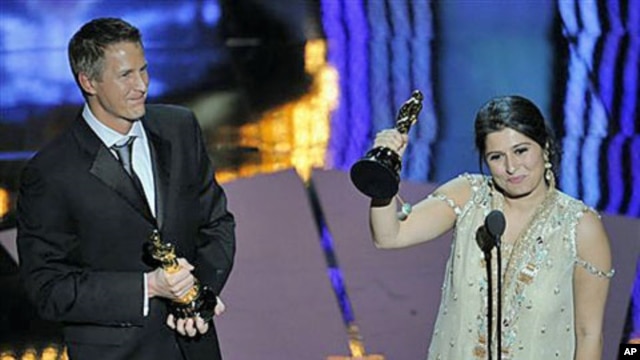 Daniel Junge (L) and Sharmeen Obaid-Chinoy accept the Oscar for best documentary short for 'Saving Face' during the 84th Academy Awards in the Hollywood section of Los Angeles, February 26, 2012.