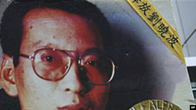 A picture of Chinese dissident Liu Xiaobo is carried by a protester during a rally demanding his release outside China's Liaison Office in Hong Kong, 11 Oct 2010 (file photo)