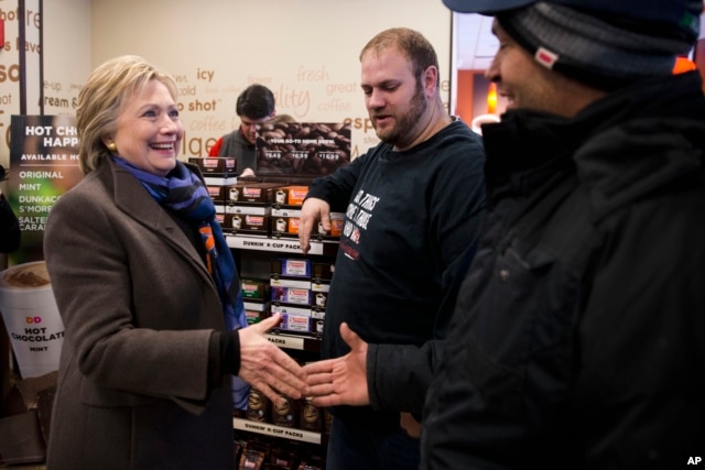 Democratic presidential candidate Hillary Clinton meets with customers as she stops at Dunkin' Donuts during the first-in-the-nation presidential primary, Feb. 9, 2016, in Nashua, N.H.
