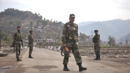 Indian army soldiers walk near the Line of Control (LOC) trade center at the Chakan Da Bagh, in Poonch, 245 kilometers (152 miles) northwest of Jammu, India, Janaury 14, 2013. 