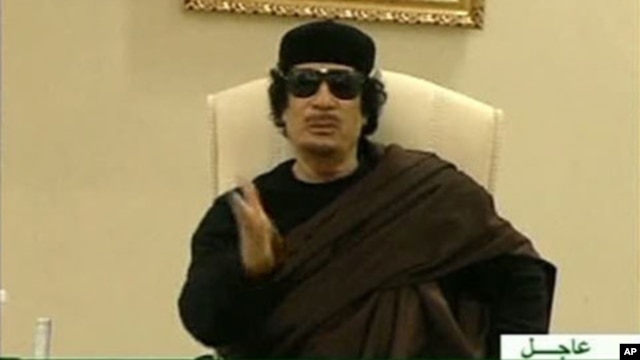 Still image from a video shows Gaddafi gesturing as he speaks at a Tripoli hotel (file photo)