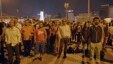 Erdem Gunduz, left, and dozens of people stand silently on Taksim Square in Istanbul early Tuesday, June 18, 2013.