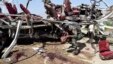 A security official collects evidence near the remains of a damaged vehicle at the site of a bomb blast in Quetta, May 23, 2013.