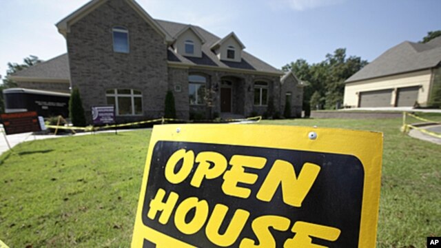An open house sign is displayed in front of a new home being readied for sale in Little Rock, Arkansas, August 22, 2011.