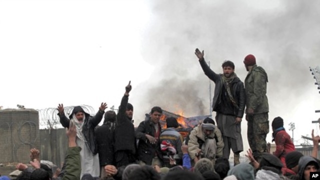 Afghan men shout anti-U.S slogans during a protest outside the U.S. military base in Baghram, north of Kabul February 21, 2012.