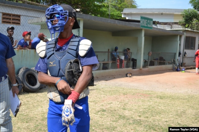 José Hernán, a catcher representing one of Havana’s three municipality teams, prepares to play at the 50th Anniversary Stadium in Cuba. He says baseball is to Cuba as football is to Brazil.