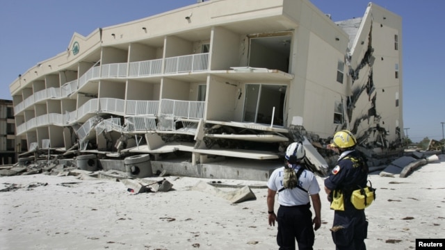 Members of the Federal Emergency and Management Agency's search and rescue team, Task Force 1 from Texas, plan their search of the Winfield Resort condominium September 17, 2004 after Hurricane Ivan struck the area in Orange Beach, Alabama.