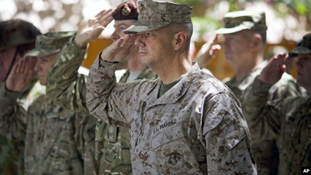 Gen. John Allen, center, the top U.S. commander in Afghanistan, salutes before he observes Memorial Day  May 28, 2012.