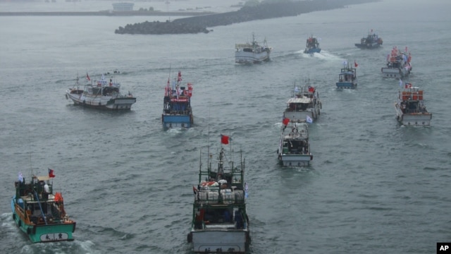Several dozen fishing boats flying Taiwanese national flags set out from the Suao harbor, northeastern Taiwan, to the disputed islands in the East China Sea, September 24, 2012. 