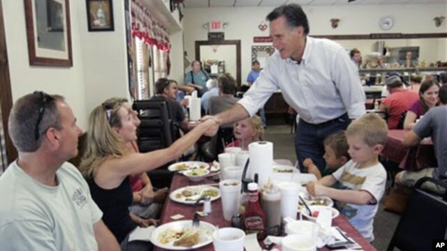 Former Massachusetts Gov. Mitt Romney shakes hands with people at Farm Boys restaurant during a visit in Chapin, S.C. Republican presidential frontrunner Romney is heading to Iowa on Friday for the first time this year, May 21, 2011