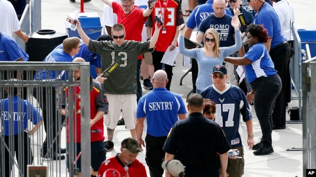 Aficionados al fútbol americano son revisados al ingresar al estadio Raymond James antes del partido entre Tampa Bay Buccaneers y Dallas Cowboys, el domingo, 15 de noviembre de 2015, en Tampa, Florida.
