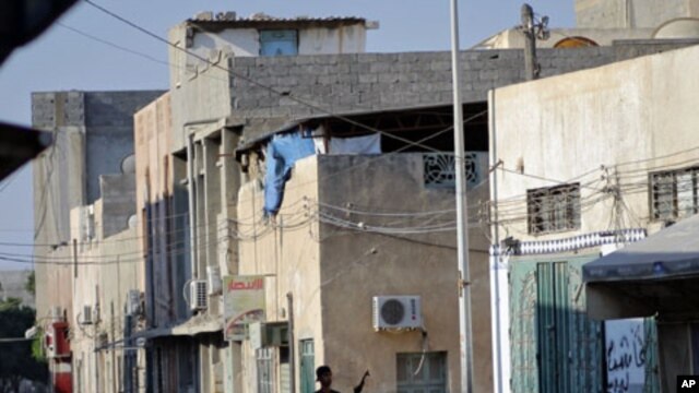 A rebel fighter walks in downtown Tripoli, Libya, August 23, 2011