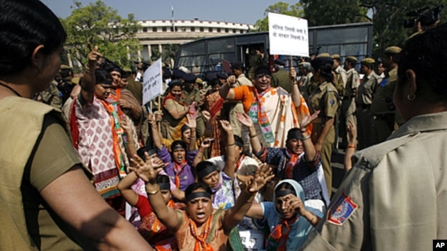 Women activists of India's main opposition Bharatiya Janata Party (BJP) shout slogans during a protest against the ruling government for the women's reservation bill in front of parliament in New Delhi, March 9, 2010.