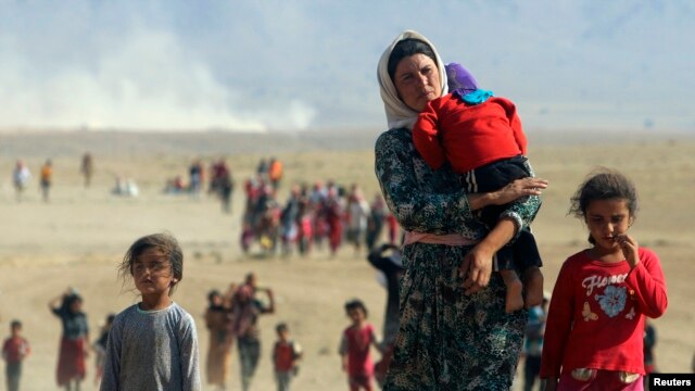 FILE - Displaced people from the minority Yazidi sect.