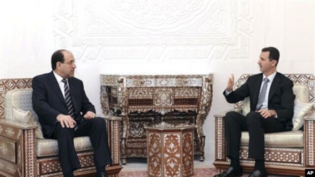 In this photo released by the Syrian official news agency SANA, Syrian President Bashar Assad, right, meets with Iraqi Prime Minister Nouri al-Maliki in Damascus, 13 Oct 2010