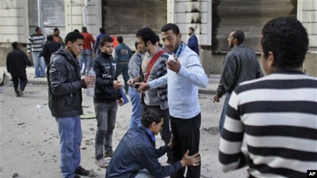 Volunteers check other anti-government protesters to search for and prevent weapons and infiltrators entering the demonstration after brief clashes with pro-government supporters in Talaat Harb square near Tahrir square, Cairo, February 4, 2011