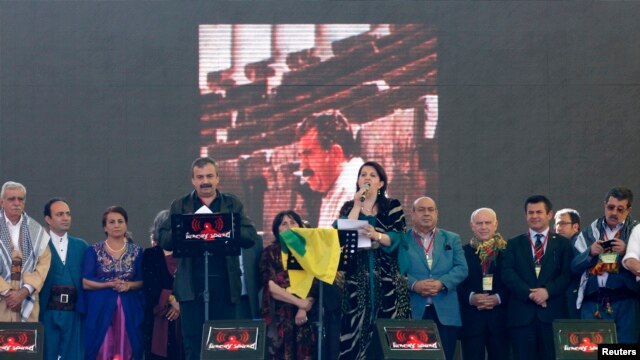 Pro-Kurdish politicians Sirri Sureyya Onder (3rd L) and Pervin Buldan (6th R) read the statement of jailed Kurdish rebel leader Abdullah Ocalan as they are flanked by other Kurdish politicians in the southeastern Turkish city of Diyarbakir, March 21, 2013