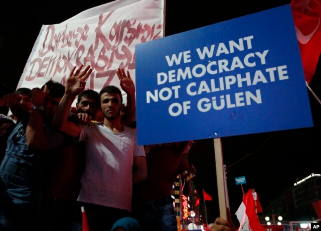 Supporters of Turkish President Recep Tayyip Erdogan hold a placard during a pro-government rally at Kizilay main square, in Ankara, Turkey, July 20, 2016.