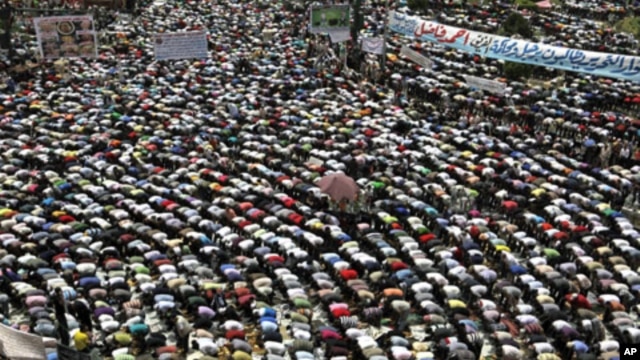 Protesters conduct Friday Prayers in Tahrir square in Cairo. Thousands of Egyptians converged on Cairo's Tahrir square on Friday in what organizers called a "second revolution" to push for deeper reforms and a speedy trial for ousted President Hosni Mubar