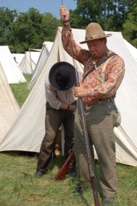 Keven Pallett, preparing his musket for the battle, has participated in US Civil War re-enactments in England, but says they're much smaller in scale there.