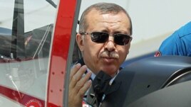 Turkish Prime Minister Recep Tayyip Erdogan in the cockpit of Hurkus (Freebird), Turkey's first locally produced military training plane, outside Ankara, Turkey, June 27, 2012 (AP).