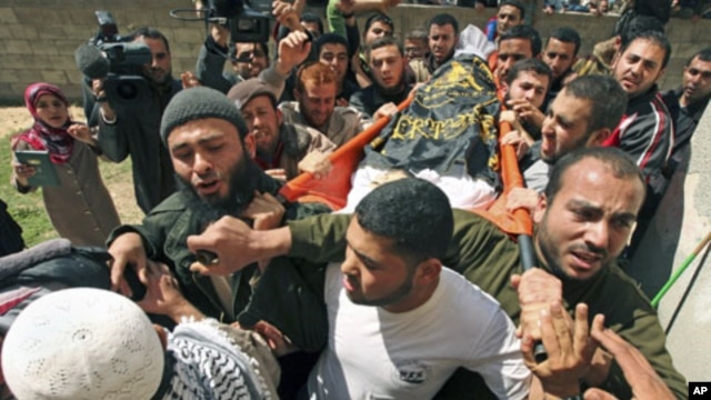 Palestinians carry the body of Islamic Jihad militant Saber Asalya during his funeral at Jabalya refugee camp in the northern Gaza Strip after Israeli aircraft killed two Palestinian militants, one of them Asalya, March 27, 2011